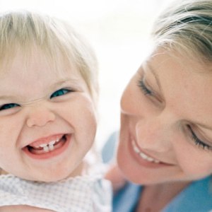 mom-holding-baby-smiling-photo-420x420-ts-78192880